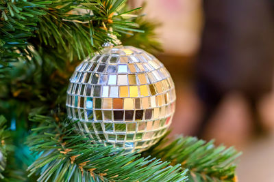 Christmas and new year holidays background. christmas tree decorated with silver disco ball. 