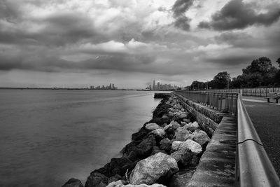 View of bridge over river against cloudy sky