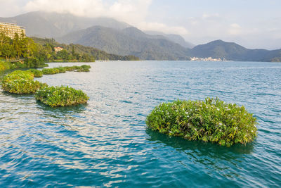 Scenic view of lake and mountains against sky