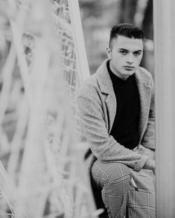 Portrait of young man sitting outdoors