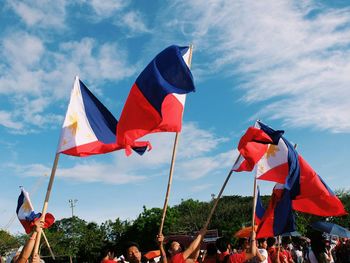 Low angle view of flags flag against sky