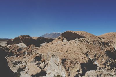 Scenic view of rocky mountains against clear blue sky