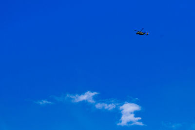 Low angle view of helicopter flying in sky