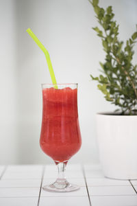 Close-up of strawberry drink in glass on table