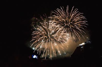 Low angle view of firework display at night