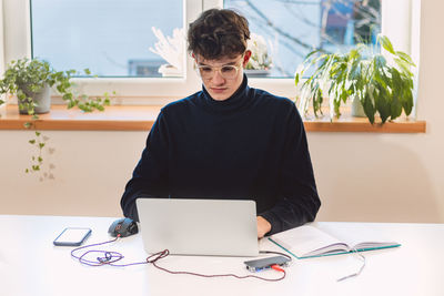 Entrepreneur in his study by the window is thinking of a new concept and strategy