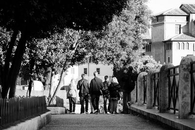 People walking on pathway along built structures