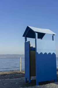 Built structure on beach against clear blue sky