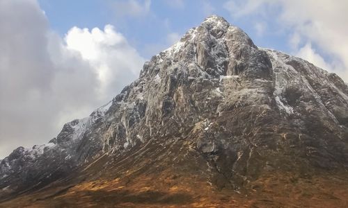 Low angle view of snowcapped mountain against sky