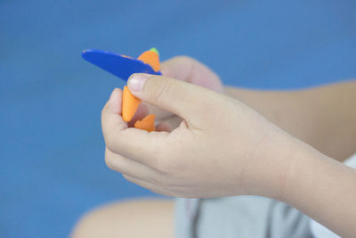 Cropped hand of person playing with clay at home