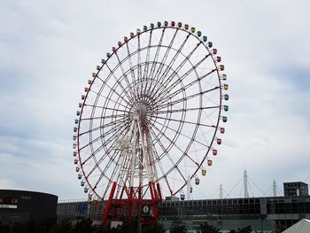 Low angle view of ferris wheel against sky