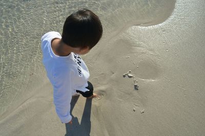 High angle view of boy standing on beach