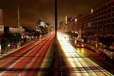 Railroad tracks in city at night