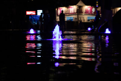 Reflection of illuminated buildings in water at night