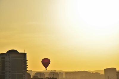 Silhouette buildings against sky during sunset