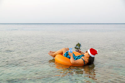 View of baby lying in sea