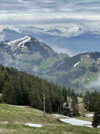 Panoramic view of townscape by mountains against sky