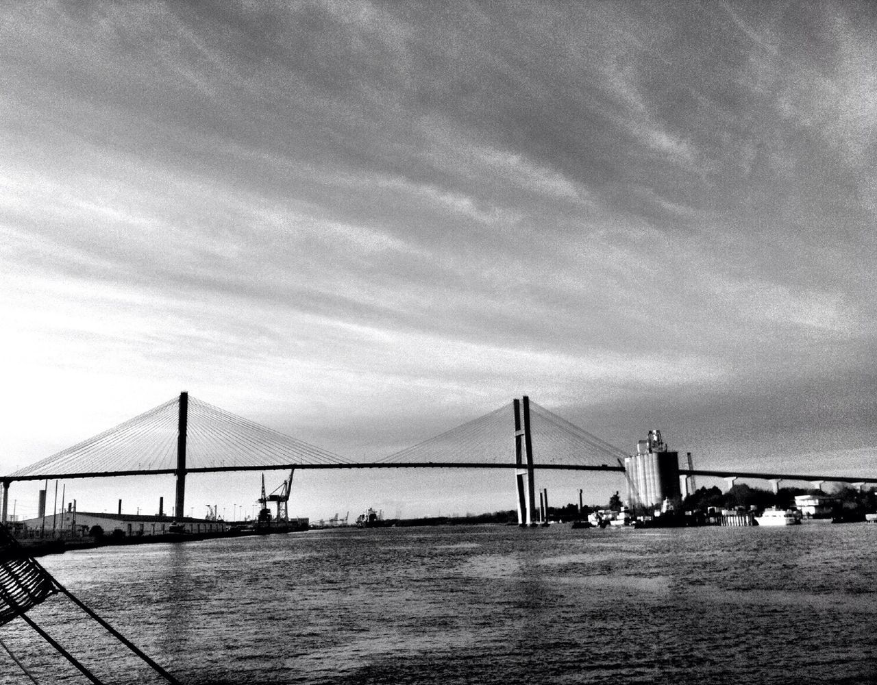 connection, bridge - man made structure, architecture, built structure, sky, water, suspension bridge, engineering, cloud - sky, bridge, river, sea, transportation, travel destinations, cloudy, waterfront, city, cloud, famous place, cable-stayed bridge