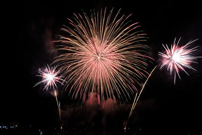 Low angle view of firework display at night