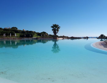 Scenic view of swimming pool against clear blue sky