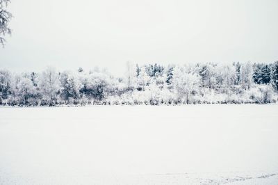 Scenic view of snow covered field against clear sky