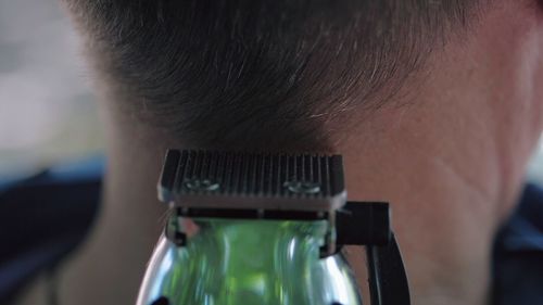 Electric razor cutting hair of man