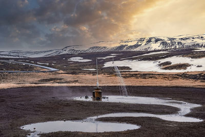 Outdoor hot shower station from geothermal power at krafla against mountain