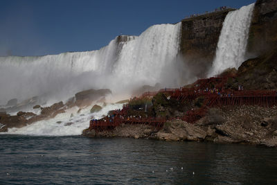Scenic view of waterfall against sky