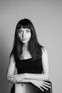 Portrait of a young woman against white background