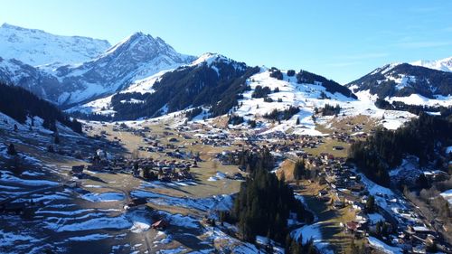 Aerial view of snowcapped mountains against sky