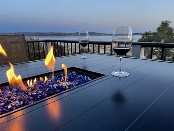 Wine glasses with sunset by fire at folsom lake.
