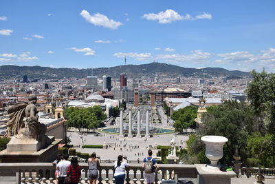 Buildings in city against cloudy sky. fira internacional de barcelona