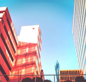 Low angle view of modern buildings against clear blue sky