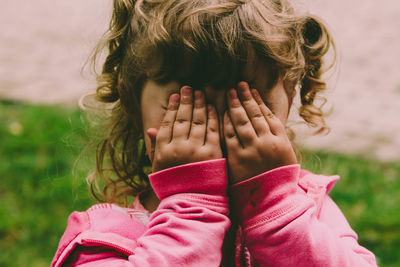 Portrait of girl wearing mask on field