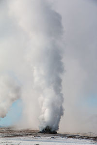 Smoke emitting from sea against sky