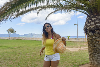 Happy latin woman with long hair smiling, having a good time  vacation in majorca hollidays concept