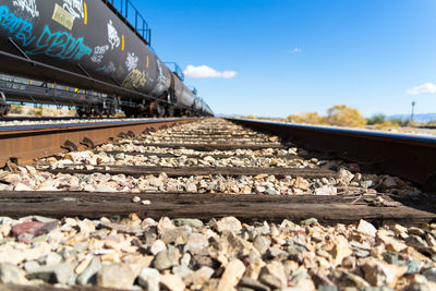 Surface level of railroad tracks against sky