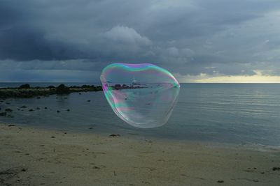 Scenic view of sea against cloudy sky
