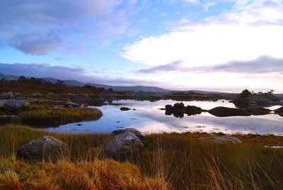 Scenic view of lake against cloudy sky