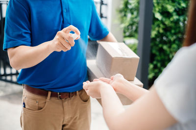 Midsection of couple holding hands