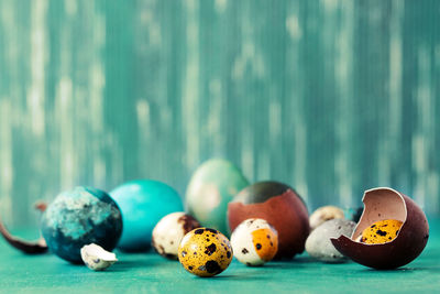 Close-up of quail eggs with eggshells on table