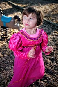 Girl in pink dress at park