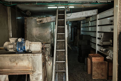 Interior of abandoned building old production workshop machine parts conveyor belt