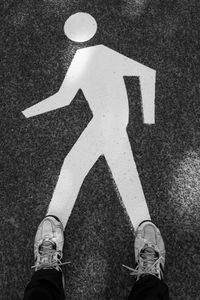Low section of man standing on road
