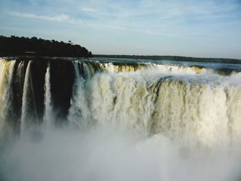 Panoramic view of waterfall against sky