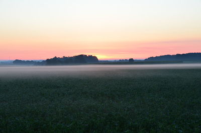 Scenic view of field against sky during sunset