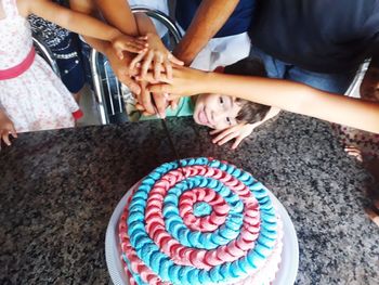 High angle view of people on cake