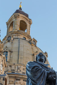 Low angle view of statue against blue sky