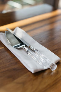 Close-up of table knives on napkin
