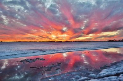 Scenic view of sea against romantic sky at sunset